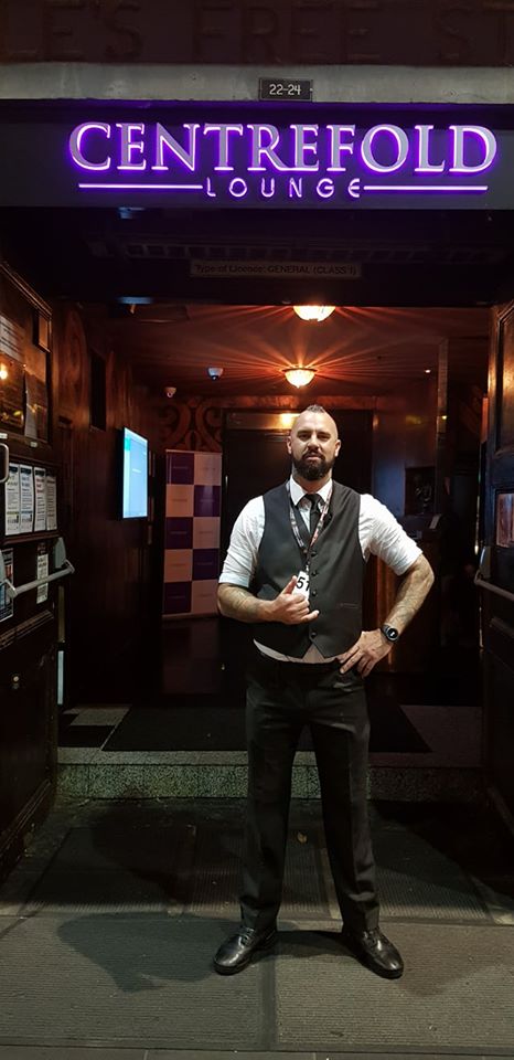 Bouncer in a vest standing at a venue entrance